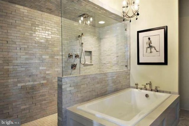 bathroom featuring plus walk in shower and a chandelier