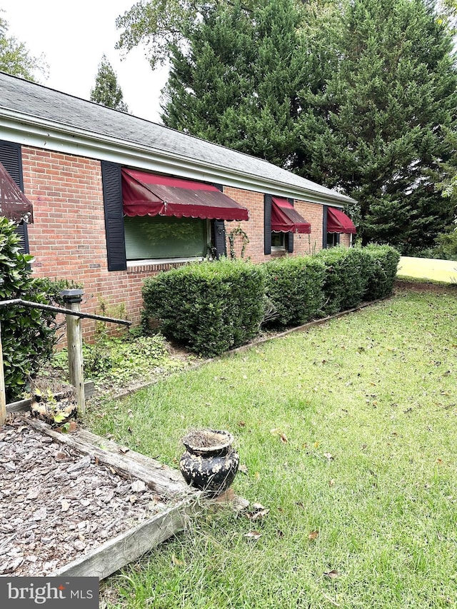 view of home's exterior with a yard