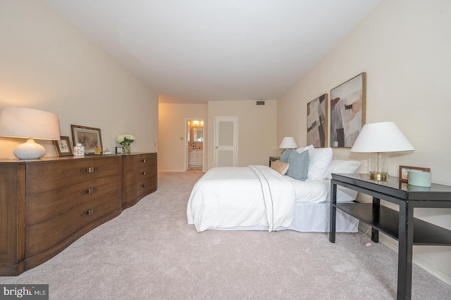 carpeted bedroom featuring ensuite bathroom