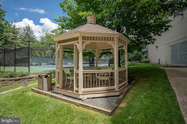 view of community with a lawn, a gazebo, and tennis court