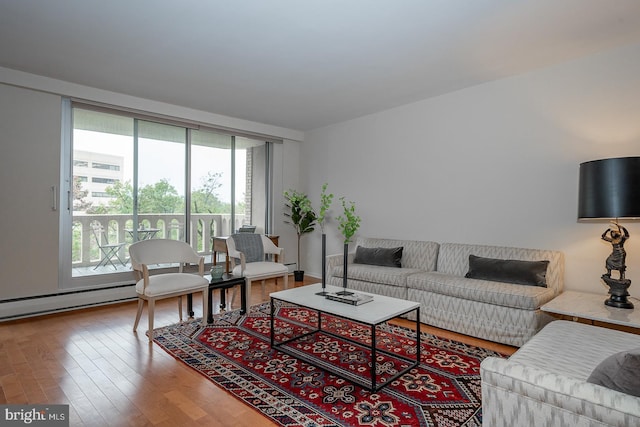 living room featuring wood-type flooring and a baseboard heating unit