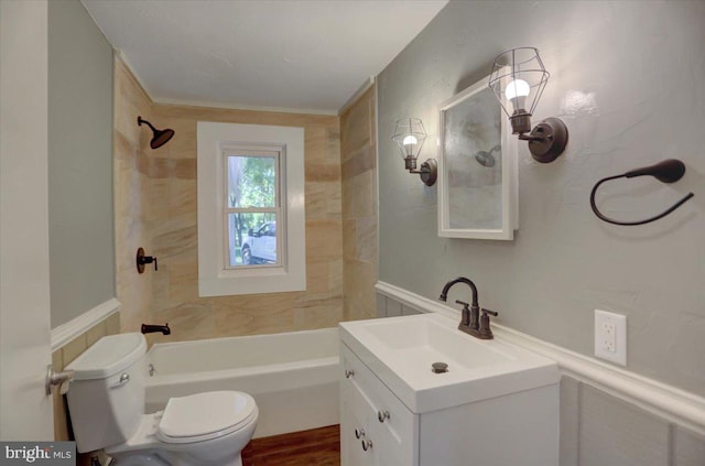 full bathroom featuring vanity, toilet, tiled shower / bath combo, and crown molding