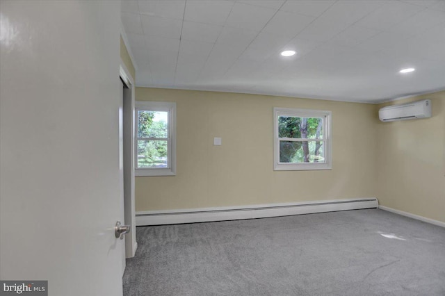 carpeted empty room featuring a baseboard heating unit and a wall mounted AC