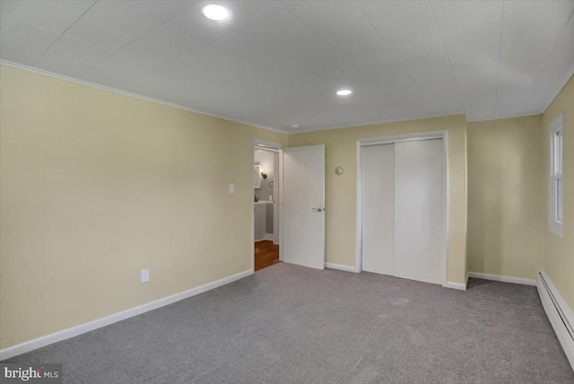 unfurnished bedroom featuring carpet flooring, a closet, and baseboard heating