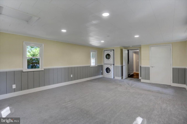 interior space featuring light carpet and stacked washer and clothes dryer