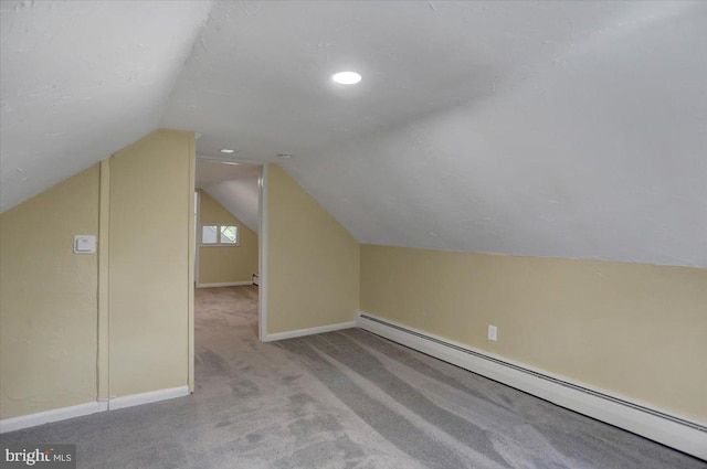 additional living space featuring light colored carpet, lofted ceiling, and a baseboard radiator