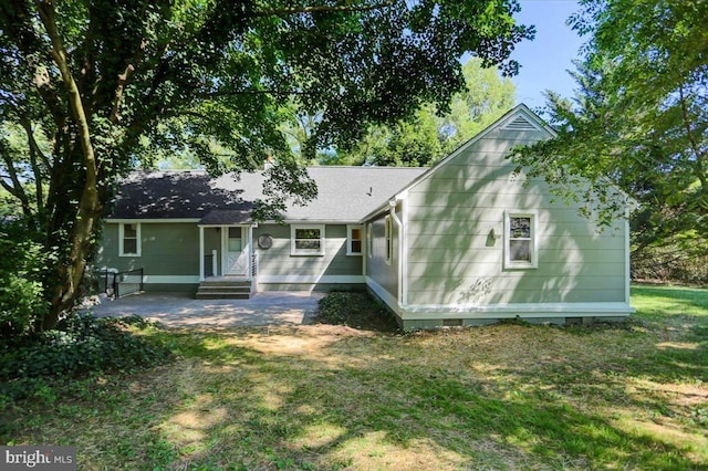 back of house featuring a patio and a lawn