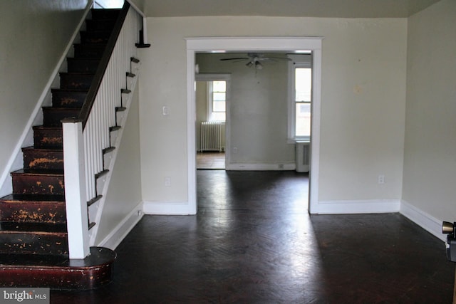 interior space with radiator heating unit and ceiling fan