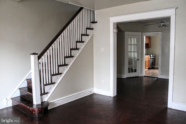 stairway featuring ceiling fan