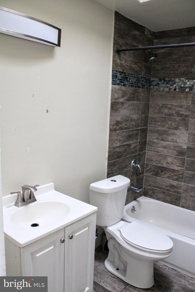 full bathroom with vanity, toilet, and tiled shower / bath