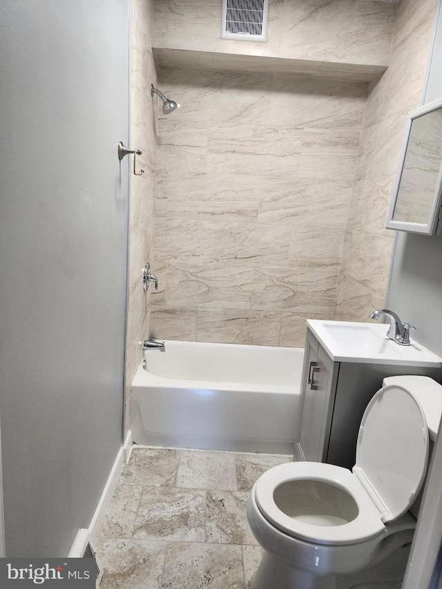 full bathroom with tiled shower / bath, vanity, and toilet