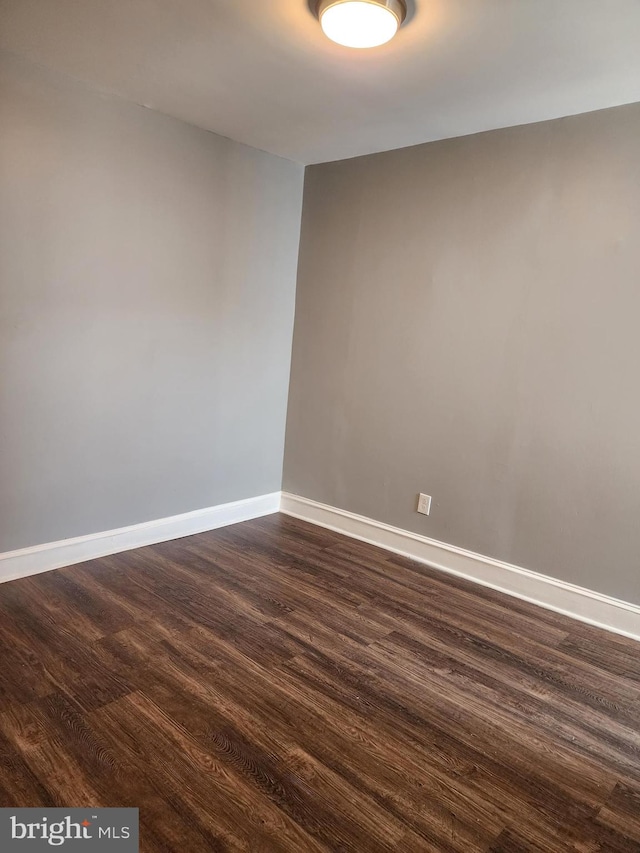 spare room featuring dark hardwood / wood-style flooring