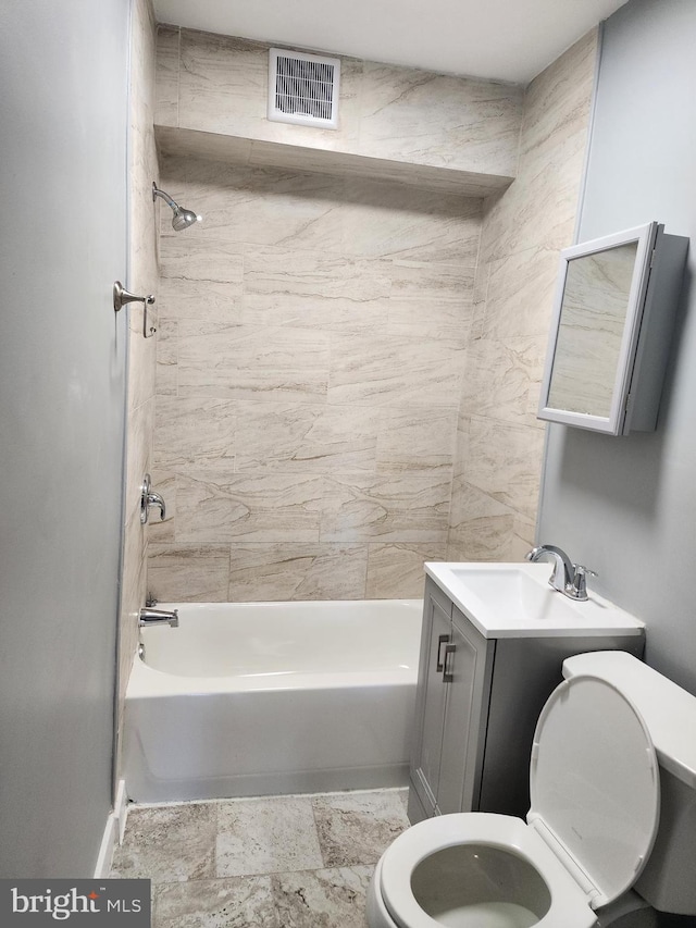 full bathroom with tiled shower / bath combo, vanity, and toilet