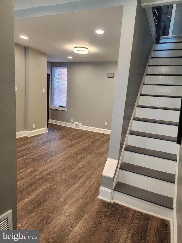 stairs with hardwood / wood-style floors