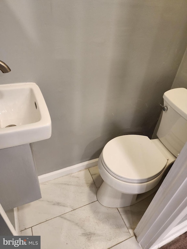 bathroom with tile patterned flooring and toilet