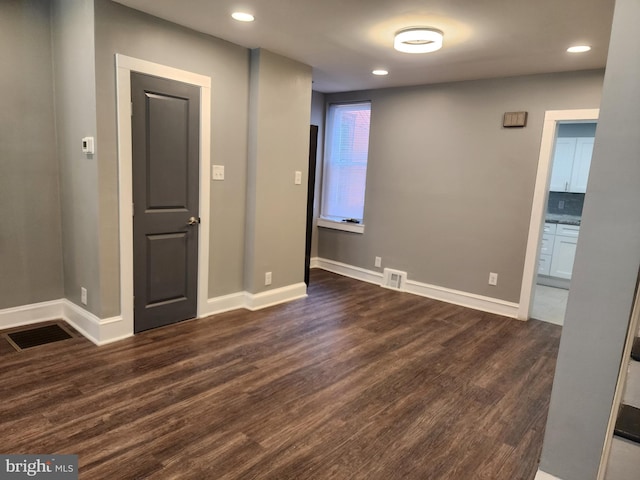 empty room featuring dark hardwood / wood-style floors