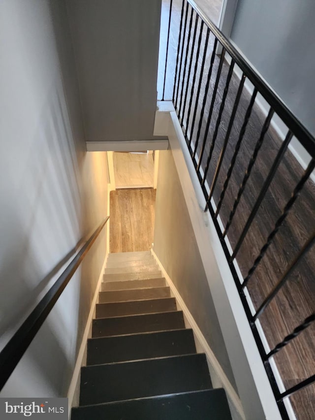 stairs with hardwood / wood-style floors