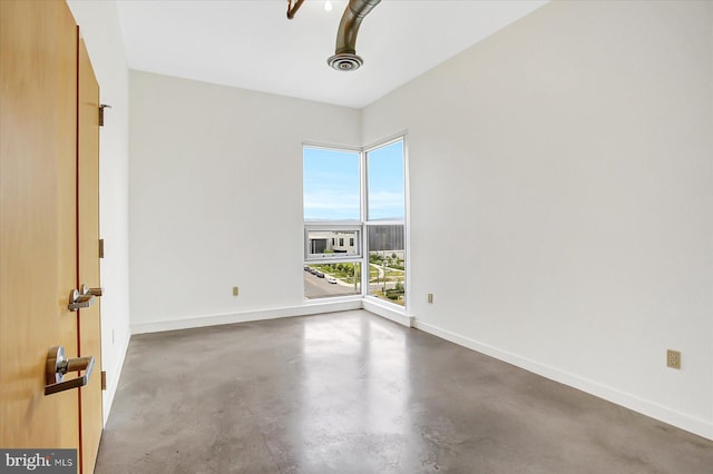 unfurnished room featuring concrete floors