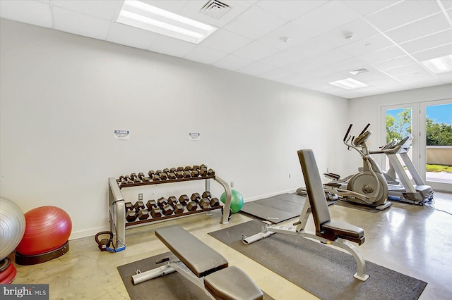 workout room featuring a drop ceiling