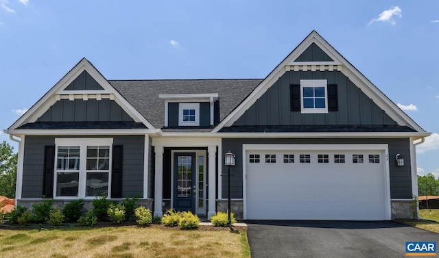 view of front of home featuring a garage and a front yard