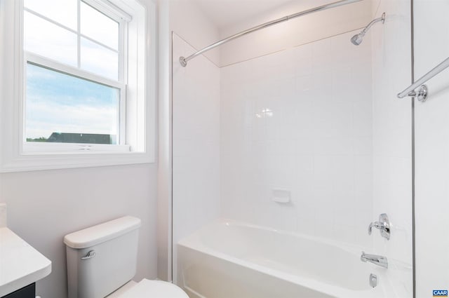 full bathroom featuring vanity, tiled shower / bath combo, and toilet