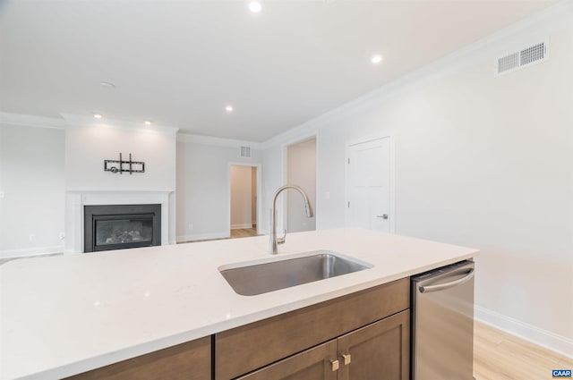 kitchen featuring stainless steel dishwasher, crown molding, sink, and light hardwood / wood-style flooring