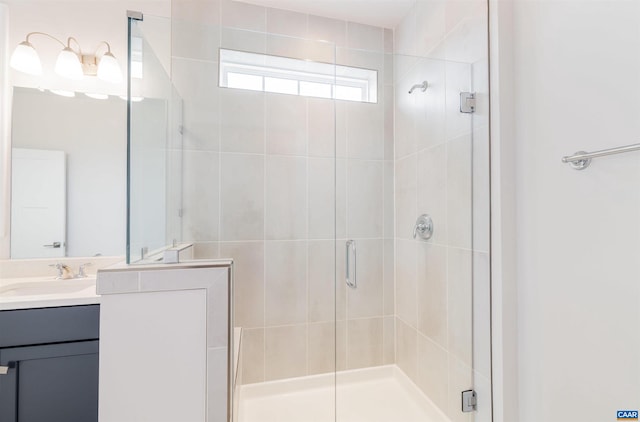 bathroom featuring vanity and a shower with shower door