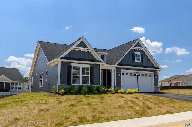 craftsman-style house featuring a garage and a front lawn