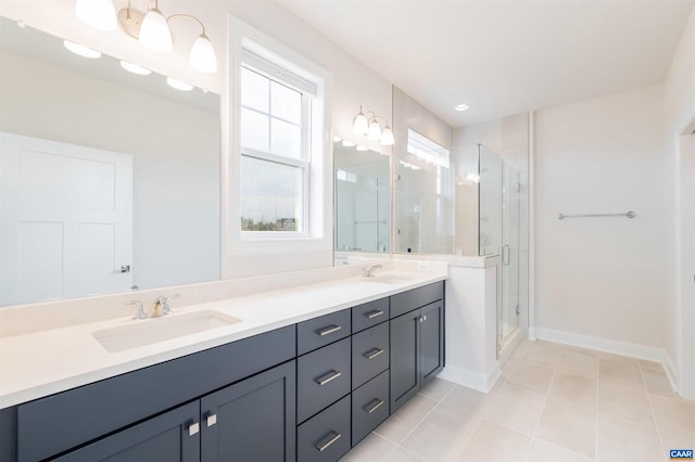 bathroom featuring tile patterned floors, vanity, and a shower with shower door