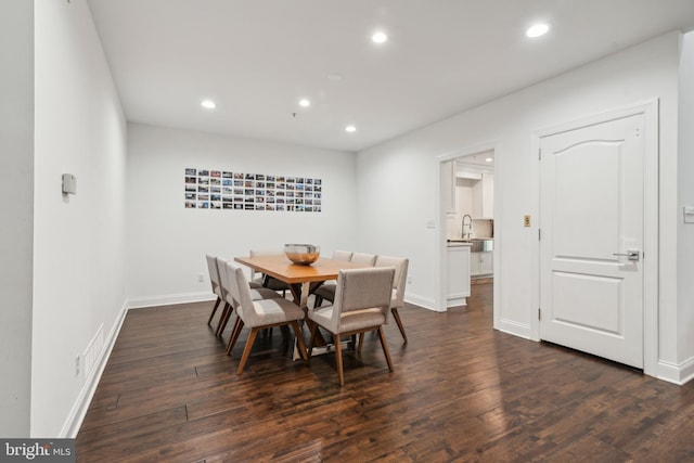 dining area featuring sink and dark hardwood / wood-style floors