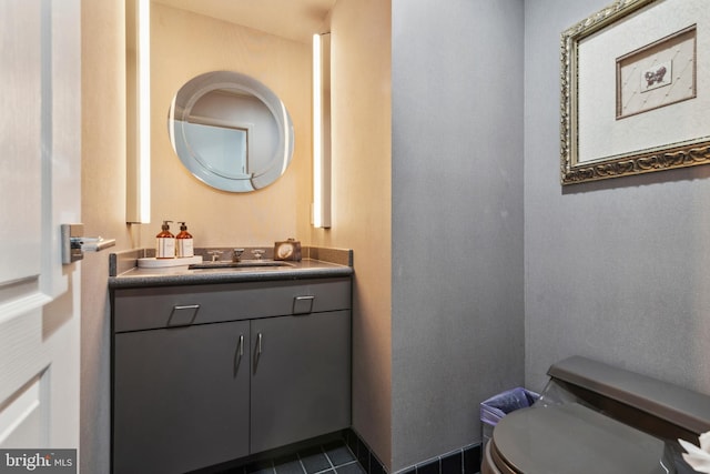 bathroom featuring tile patterned flooring, vanity, and toilet