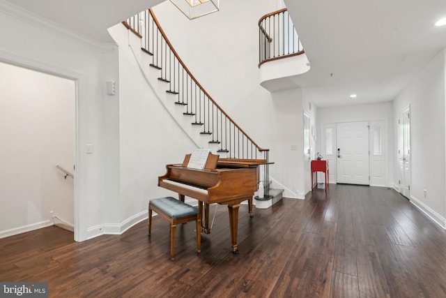 entryway with dark hardwood / wood-style flooring and ornamental molding