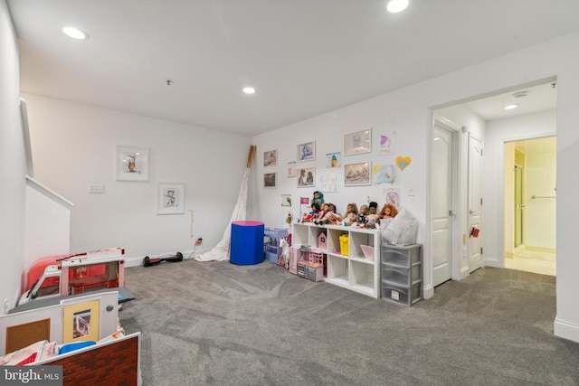 game room with dark colored carpet