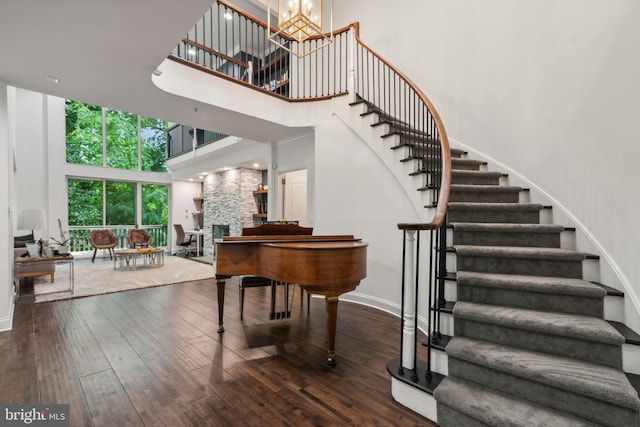 interior space featuring a high ceiling, dark wood-type flooring, and a notable chandelier