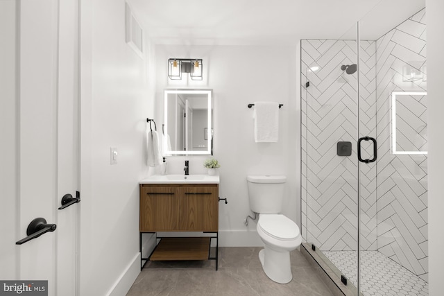 bathroom with tile patterned flooring, vanity, toilet, and walk in shower