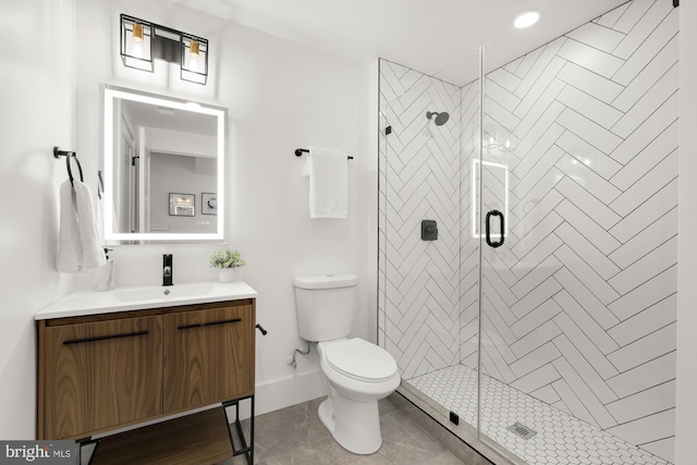 bathroom featuring tile patterned flooring, vanity, toilet, and a shower with shower door