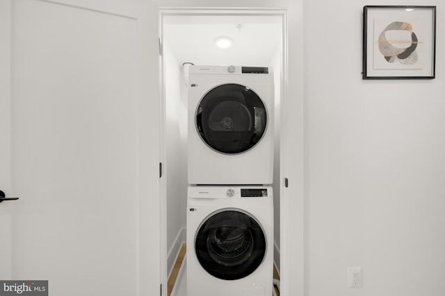 laundry area with stacked washing maching and dryer