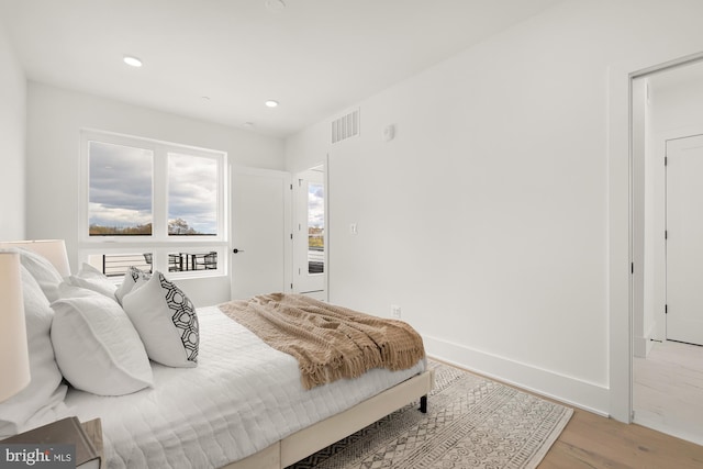 bedroom with hardwood / wood-style floors