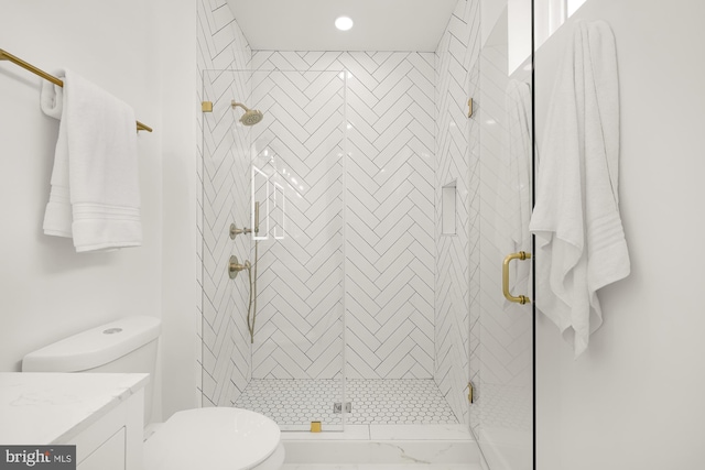 bathroom with an enclosed shower, vanity, and toilet