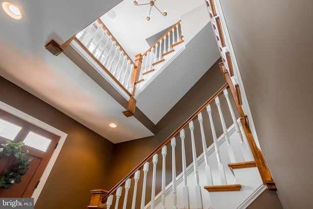 staircase featuring a high ceiling