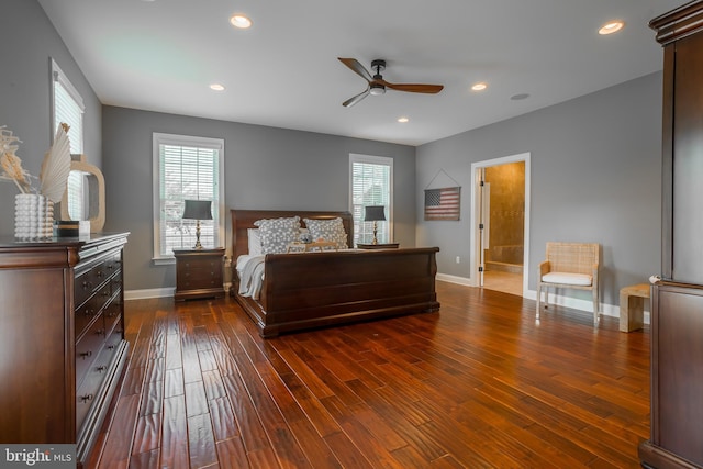 bedroom with ensuite bath, dark wood-type flooring, and ceiling fan