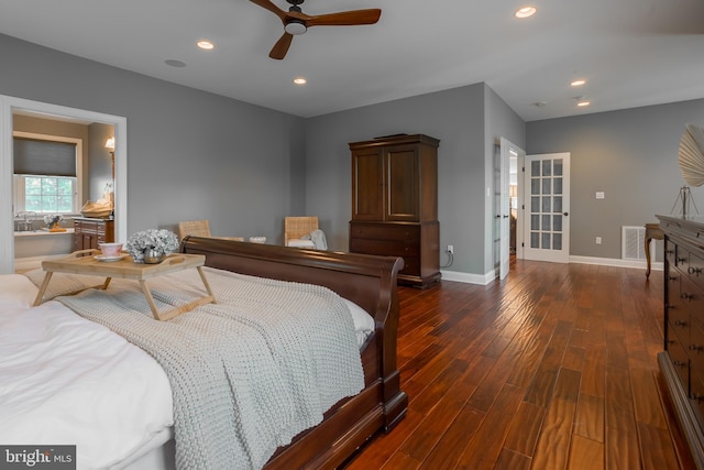 bedroom featuring dark hardwood / wood-style floors, ensuite bath, and ceiling fan