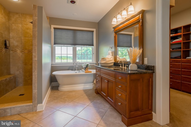 bathroom with plus walk in shower, vanity, and tile patterned floors