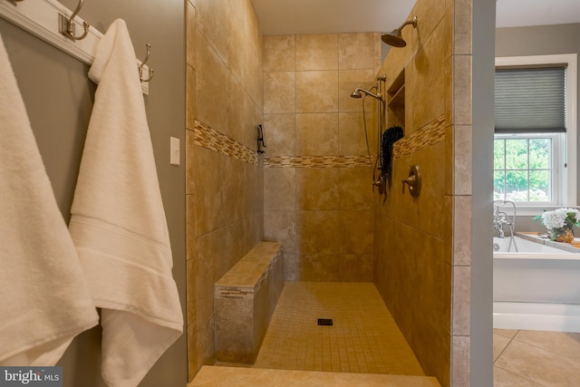 bathroom with independent shower and bath and tile patterned floors