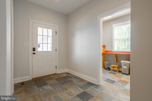 entryway featuring dark tile patterned flooring