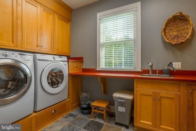 clothes washing area featuring sink, cabinets, independent washer and dryer, and dark tile patterned flooring