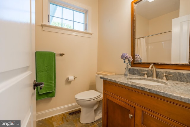 bathroom featuring toilet and vanity