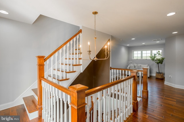 stairway with hardwood / wood-style floors