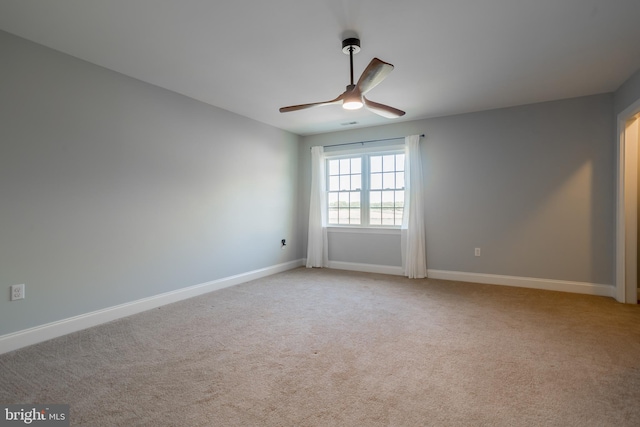 unfurnished room featuring ceiling fan and light colored carpet