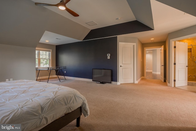 carpeted bedroom with ensuite bathroom, ceiling fan, and lofted ceiling